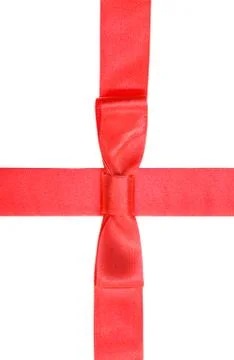 Intersection of red silk ribbon and band with bow Fotos de archivo
