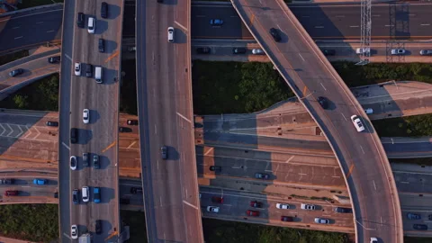 Intersection of roads in the multi-level interchange. Numerous cars move by the Stock Footage 347677743