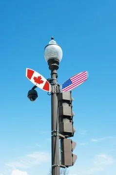Intersection street sign with direction to canada or united states of america Stock Photos