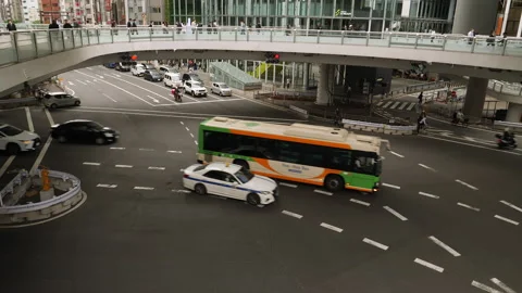 Intersection with traffic and pedestrian bridge. Shibuya district. Tokyo, Japan. Stock Footage 246410230
