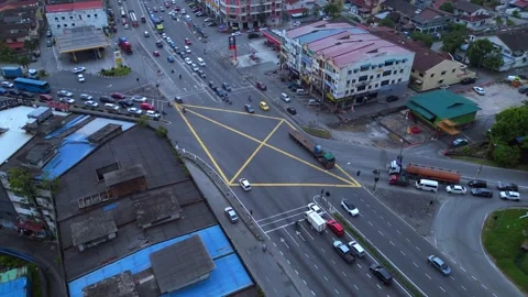 Intersection traffic flowing at Port Klang downtown. Dramatic aerial view drone Stock Footage 336287453