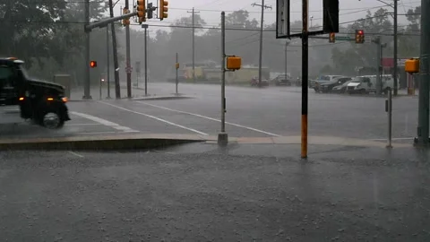 Intersection with traffic, rain and hail in slo mo. Stock Footage 134846261
