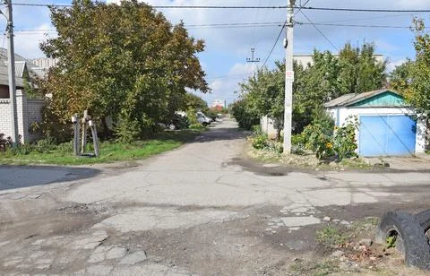 The intersection of two streets in the city of Kherson. Crossroad with bad road. Stock Photos