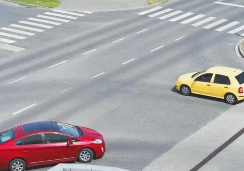 Intersection with Yellow and Red Car Stock Photos