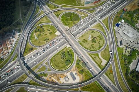 Intersections in metropolis. Traffic on highway at summer. Top view. Stock Photos
