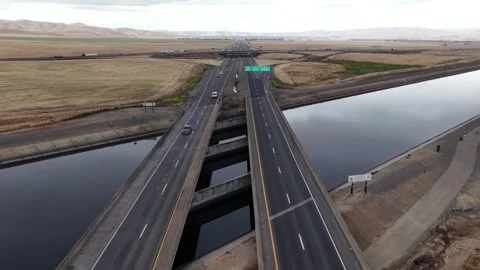 Interstate 5 freeway bridge crossing California Aqueduct near Los Banos with Stock Footage 335218669