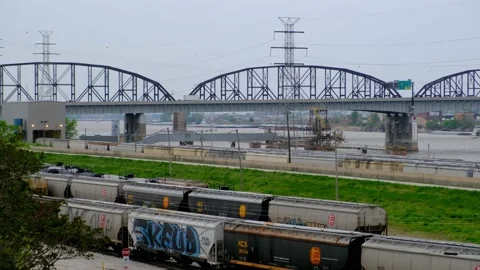 Interstate 55  Bridge seen from Mississippi River Overlook with train cars Video stock 166363513