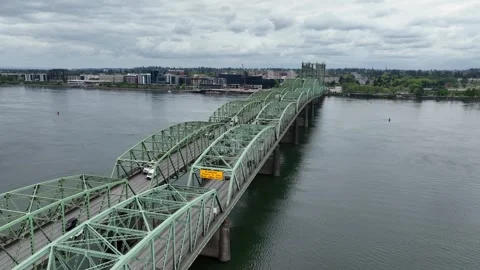 Interstate Bridge steel truss structure spanning calm Columbia River between Stock Footage 335474784