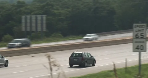 Interstate Highway Traffic - Panning Shot - Weeds Stock Footage 77908460