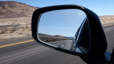 INTERSTATE TRAVEL ON I-80 THROUGH NEVADA DESERT AS SEEN IN SIDE MIRROR Stock Footage 96228296