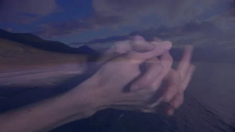 Intertwined hands over scenic mountain and ocean landscape with animation Video stock 305835949