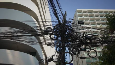 Intertwined Tangled Power Lines and Urban Architectural Designs are Stock Footage 319909422