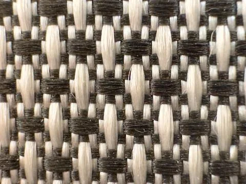 Intertwined threads of fabric surface with black and white pattern. 库存照片