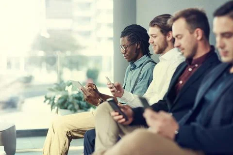 Interview, group and man with tablet in waiting room for job opportunity, o.. Foto stock