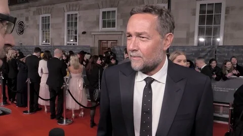 Interview with Phedon Papamichael at red carpet during BAFTAs - London 2020 Stock Footage 125802922