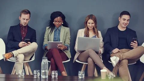 Interview, row or people with tech in waiting room for job opportunity, onl.. Foto stock