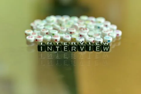 INTERVIEW written with Acrylic Black cube with white Alphabet Beads on the Gl Stock Photos