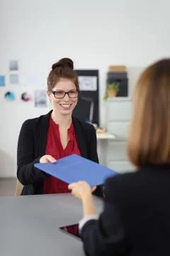 Interviewee handing out her cv Stock Photos