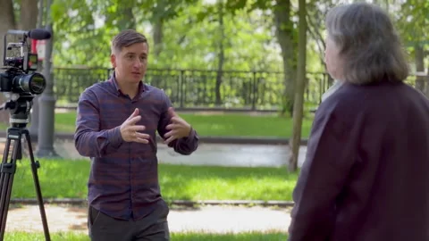 The interviewer communicates with the speaker. The work of a journalist Stock Footage 246176303