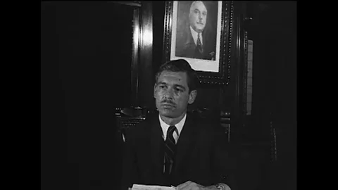 An interviewer poses questions to General Rafael Trujillo. Stock Footage 115356944