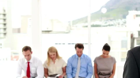 Interviewer smiling at camera in front of applicants Stock Footage 40394949