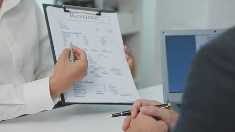 Interviewing hiring manager with resume and job application paperwork Stock Footage 325445702
