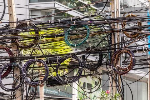 Interweaving of power cables, countless cables suspended on the streets of Ba Stock Photos