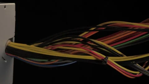 Interweaving of wires of different colors on a black background Stock Footage 131152684