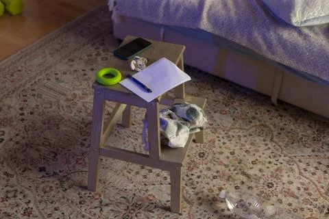 Intimate ambiance created by bedside objects on patterned rug with soft glow Stock Photos