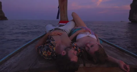 Intimate and in love couple on authentic sunset romantic long tail boat tour in Video stock 201094430