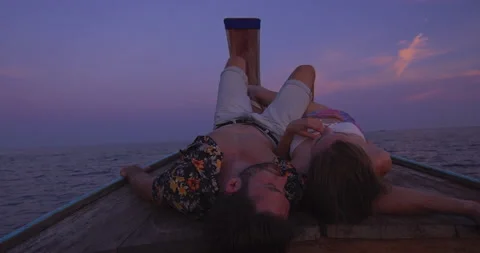 Intimate and in love couple on authentic sunset romantic long tail boat tour in Vídeos de archivo 201094550