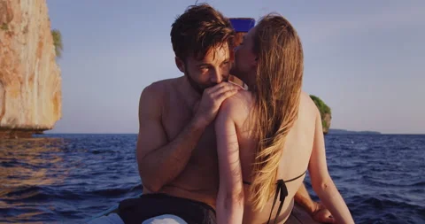 Intimate and in love couple on authentic, romantic long tail boat tour at sunset Stock Footage 201094824