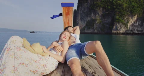 Intimate and in love couple on authentic, sunset romantic long tail boat tour in Stock Footage