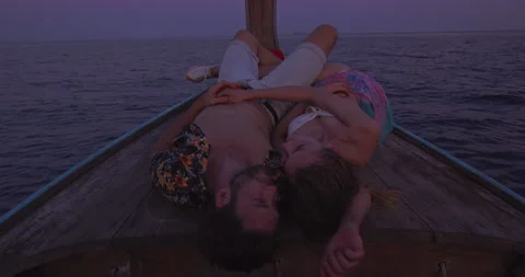 Intimate and in love couple on authentic sunset romantic long tail boat tour in Видео 201095551
