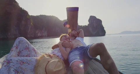 Intimate and in love couple on authentic, sunset romantic long tail boat tour in Stock Footage 201095920
