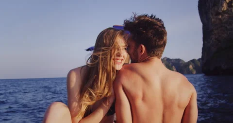 Intimate and in love couple on authentic, romantic long tail boat tour at sunset Stock Footage 201096912