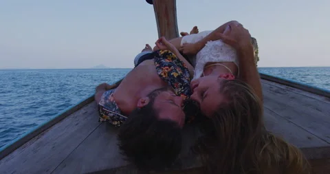 Intimate and in love couple on authentic sunset romantic long tail boat tour in Stock Footage 201097182