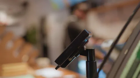 Intimate cafe scene. Modern card reader at inviting coffee shop counter Stock Footage 335762465