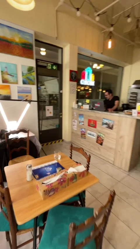 Intimate cafe setting. Warm and inviting cafe with artistic decor Stock Footage 335434816
