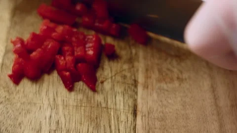 Intimate chef knife slicing white onion on a wooden board in warm light, 4K Stock Footage 341107613