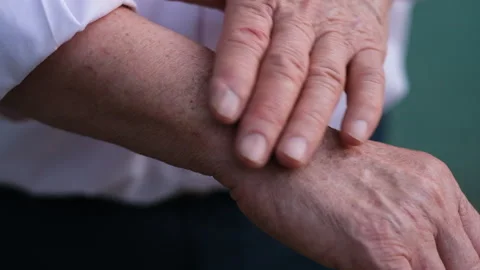 An intimate close-up of two hands showcasing the signs of age and experience 스톡 동영상 323370954