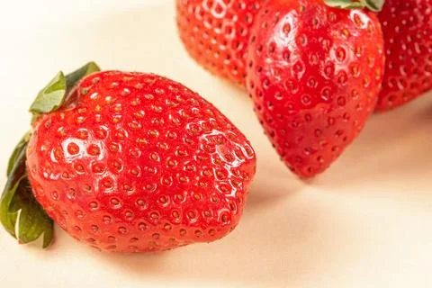 Intimate close-up view of vibrant ripe strawberries on dark background Stock Photos