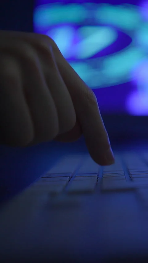 An Intimate CloseUp of a Finger Delicately Hovering Above a Keyboard in a Stock Footage 295999722