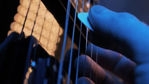 An Intimate CloseUp of Guitar Strings Illuminated in Creative and Artistic Stock Footage 305269533