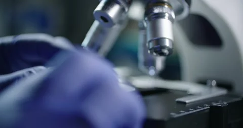 Intimate CloseUp of Scientist Using Microscope in a Laboratory Setting Stock Footage 299715560
