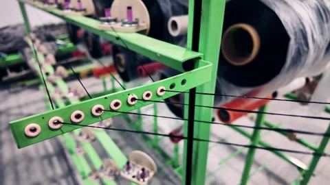 An Intimate CloseUp of Textile Equipment Alongside Beautifully Organized Thread Stock Footage 323611461
