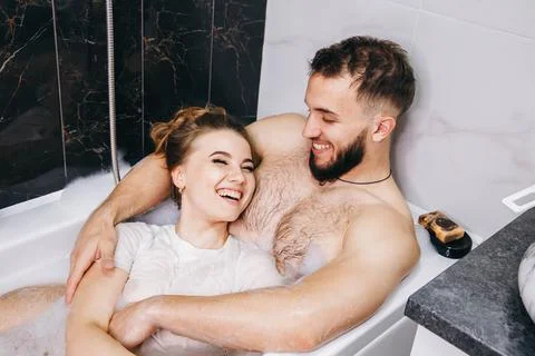 Intimate couple is spending nice time. Couple kissing in bathtub. Fotos de archivo