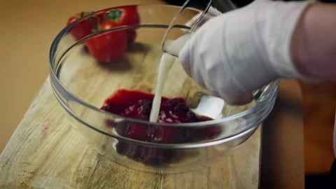 Intimate flour folded into naturally colored beet paste in kitchen, 4K Stock Footage 341111552