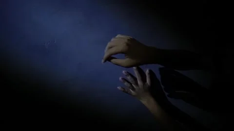 Intimate Hands Reaching Towards a Wall in Dim Light Stock Footage 313468164