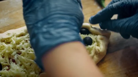 Intimate minced meat mixture spread over fresh pide dough in profile, 4K Stock Footage 341114213